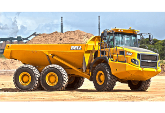 A Bell Trucks B25E is driving with a load of dirt at an industrial site near South Hadley, MA.